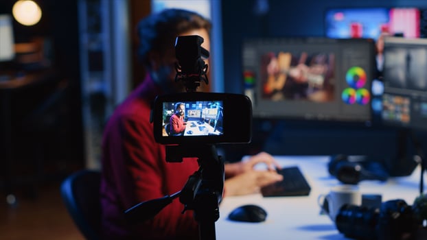 Photographer content creator using professional camera to record basic photography editing techniques guide for beginners, selling online course. Freelancer filming photo adjusting tutorial, zoom out