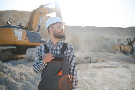 Male worker with bulldozer in sand quarry photo