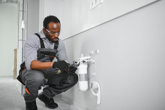 African american plumber change the water filter. photo