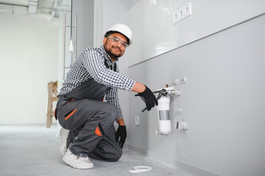 plumber installing water equipment - meter, filter and pressure reducer photo