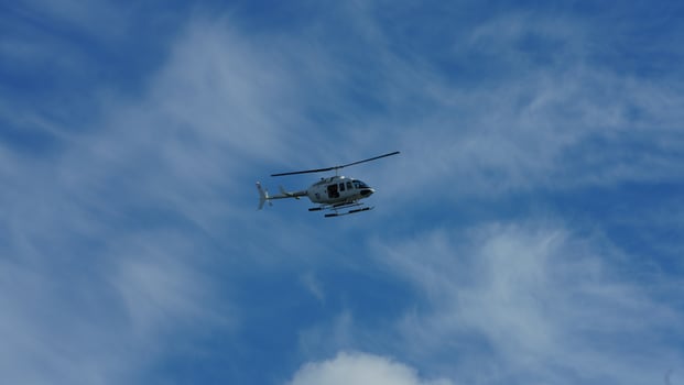 One helicopter flying over in the blue sky in autumn photo