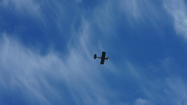 One plane flying over in the blue sky in autumn photo