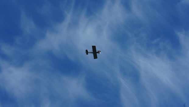 One plane flying over in the blue sky in autumn photo