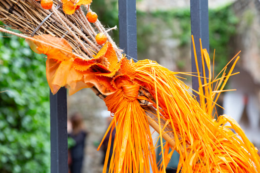 Orange halloween decoration hanging on a metal fence outdoors photo
