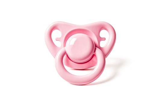 Pink baby pacifier isolated on white background photo