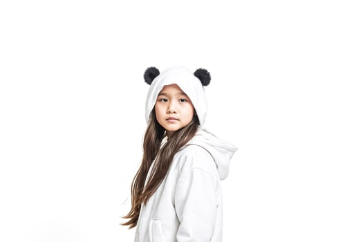 Young girl with panda ears hoodie looking at camera photo