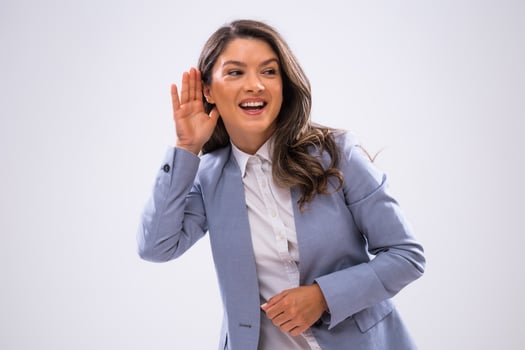 Portrait of happy businesswoman who is eavesdropping. photo