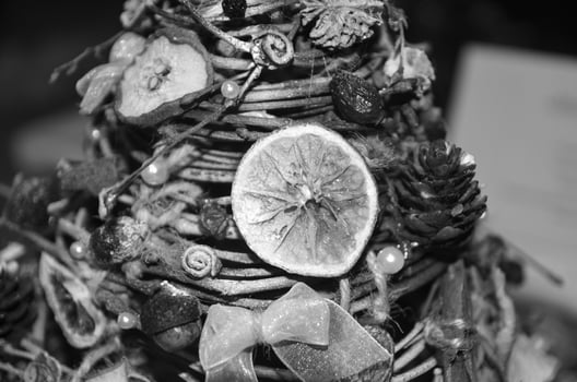 Christmas tree made of fruits and berries. Black and white monochrome grayscale photo background.