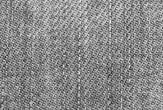 Blue jeans cloth texture close view. Black and white monochrome grayscale photo background.