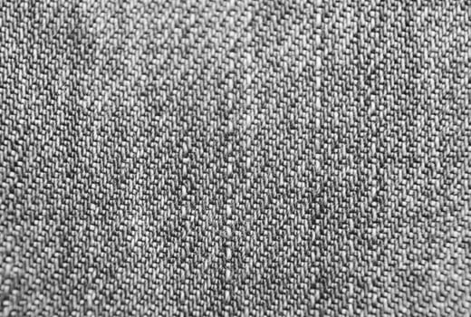 Blue jeans cloth texture close view. Black and white monochrome grayscale photo background.
