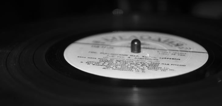 Retro vinyl record disc. Black and white monochrome grayscale photo background.