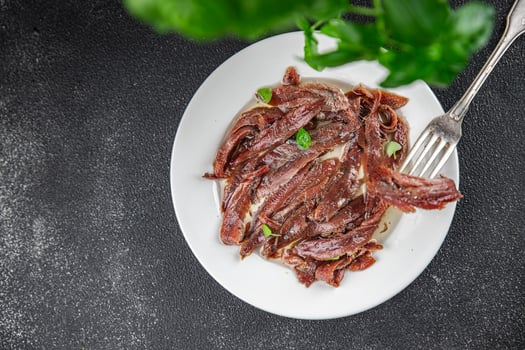 anchovies in a plate on the table canned fish in oil fresh and tasty seafood meal food snack on the table copy space food background rustic photo
