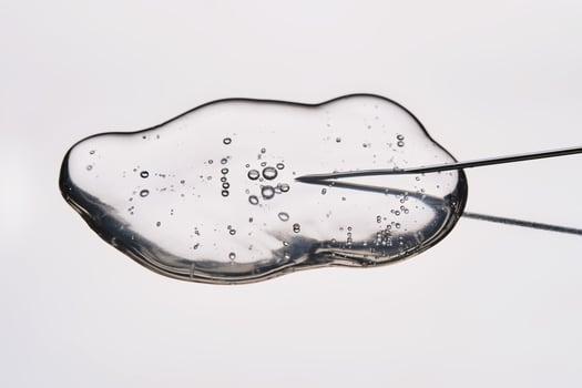 A drop of medicine flowing from a syringe with a needle. photo
