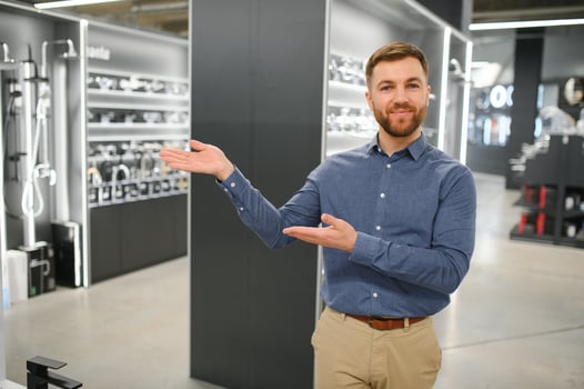 Portrait of salesperson in bathroom store. Happy man works in bath store. Sales occupation photo