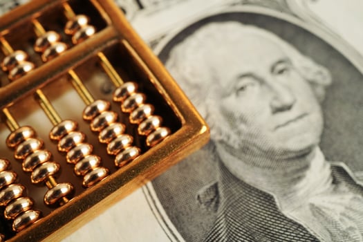 Gold abacus on banknote money, finance trading investment business currency concept. photo