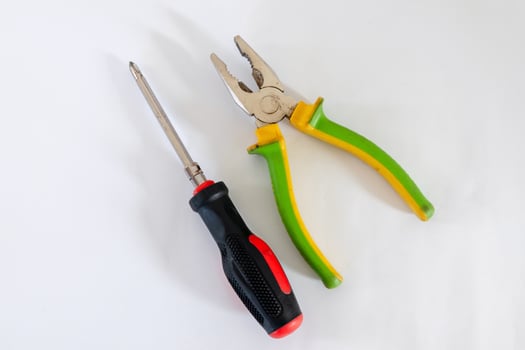 Screwdriver and pliers isolated on white background photo