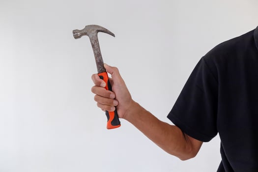 Man holding a hammer on a white background photo