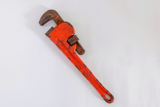 A rusty pipe wrench on a white background photo