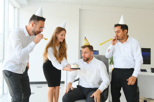 corporate party and people concept - happy team with cake celebrating colleague birthday at office photo