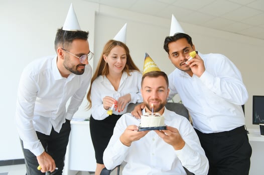 corporate party and people concept - happy team with cake celebrating colleague birthday at office photo