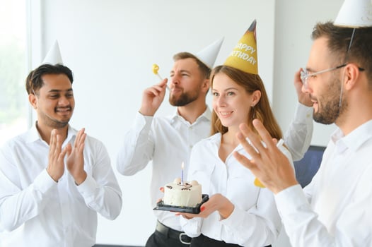 Business team celebrating a birthday of collegue in the modern office. photo
