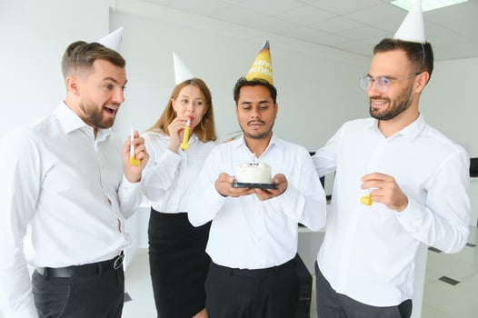 Surprise. Mixed race happy people celebrating a birthday of colleague in the modern office photo