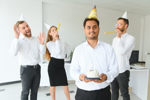 Surprise. Mixed race happy people celebrating a birthday of colleague in the modern office photo