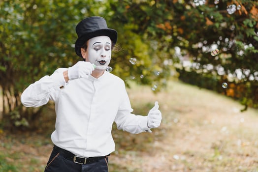 Mime artist blowing a bubble photo
