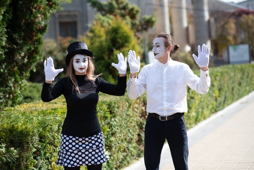 A couple of merry mimes. He hurries on a date. photo