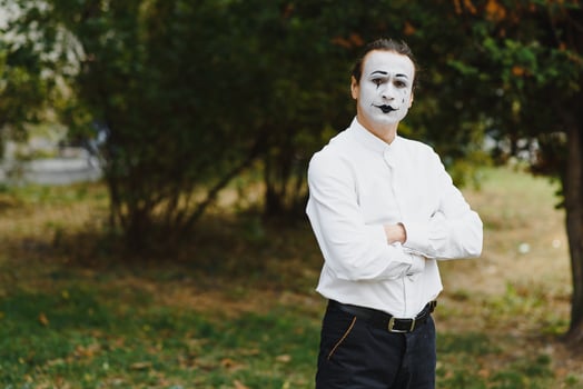 Portrait of a man, artist,clown, MIME. Shows something. Mime actor shows different emotions. photo