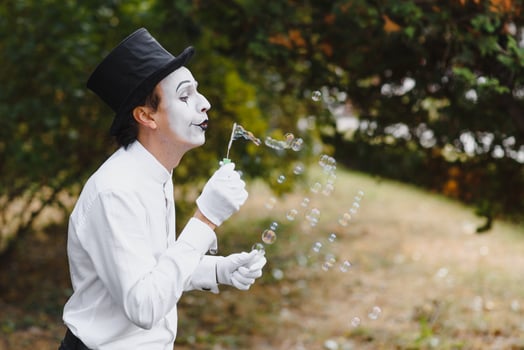 Mime artist blowing a bubble photo