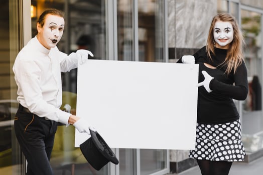 couple funny mimes holding sign photo