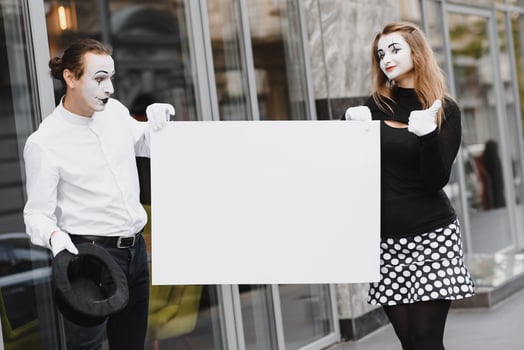 couple funny mimes holding sign photo