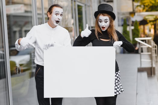 couple funny mimes holding sign photo