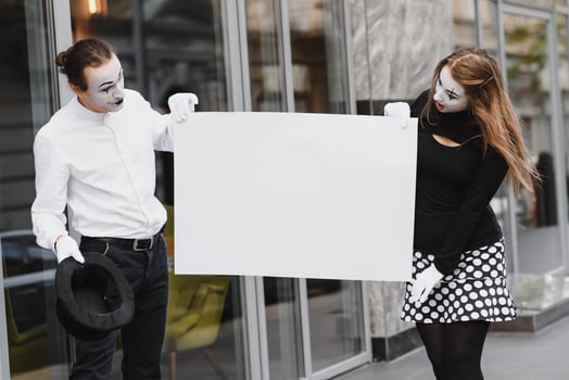 couple funny mimes holding sign photo
