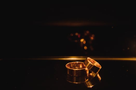 Beautiful wedding gold rings on dark background photo