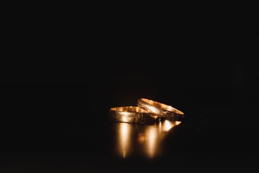 Beautiful wedding golden rings on dark background photo