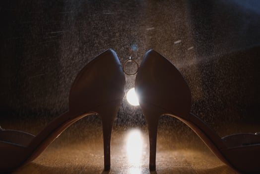 Beautiful wedding ring on the bride's white shoes photo