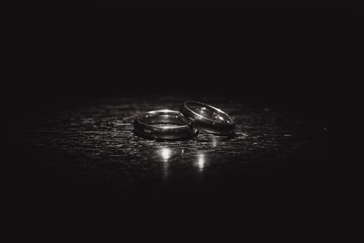 Beautiful wedding gold rings on dark background photo