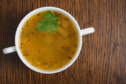 A picture of a bowl of traditional chicken soup served in a bowl over wooden background photo