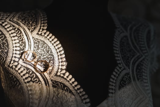 Beautiful wedding gold rings on dark background photo