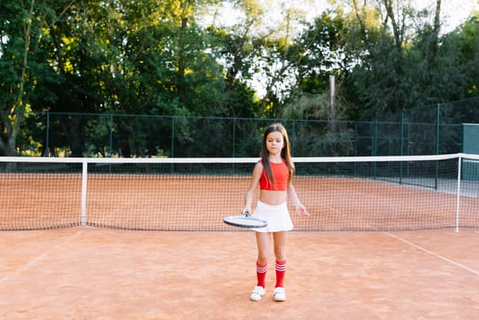 portrait of a little girl on the tennis court photo