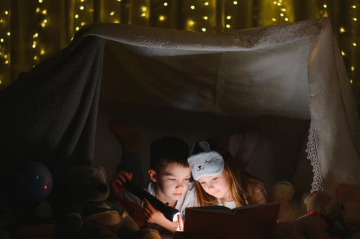 Little children reading bedtime story at home photo