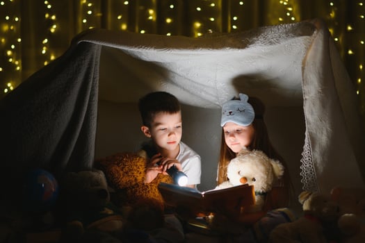 Little children reading bedtime story at home photo