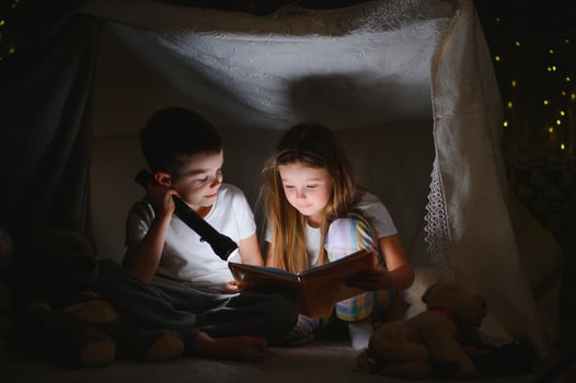 Little children reading bedtime story at home photo