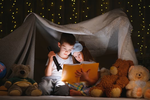 Little children reading bedtime story at home photo