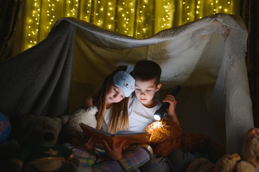 Little children reading bedtime story at home photo
