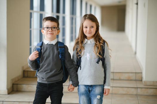 Happy school kids in corridor at school photo