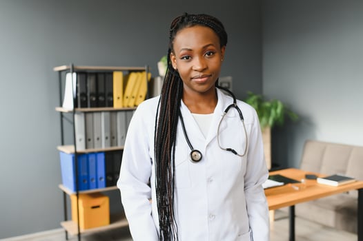Portrait Of Smiling Female Doctor Wearing White Coat With Stethoscope In Hospital Office. photo