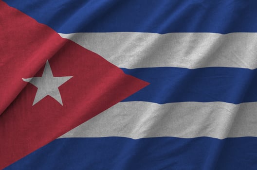 Cuba flag depicted on folded wavy fabric of old cloth photo